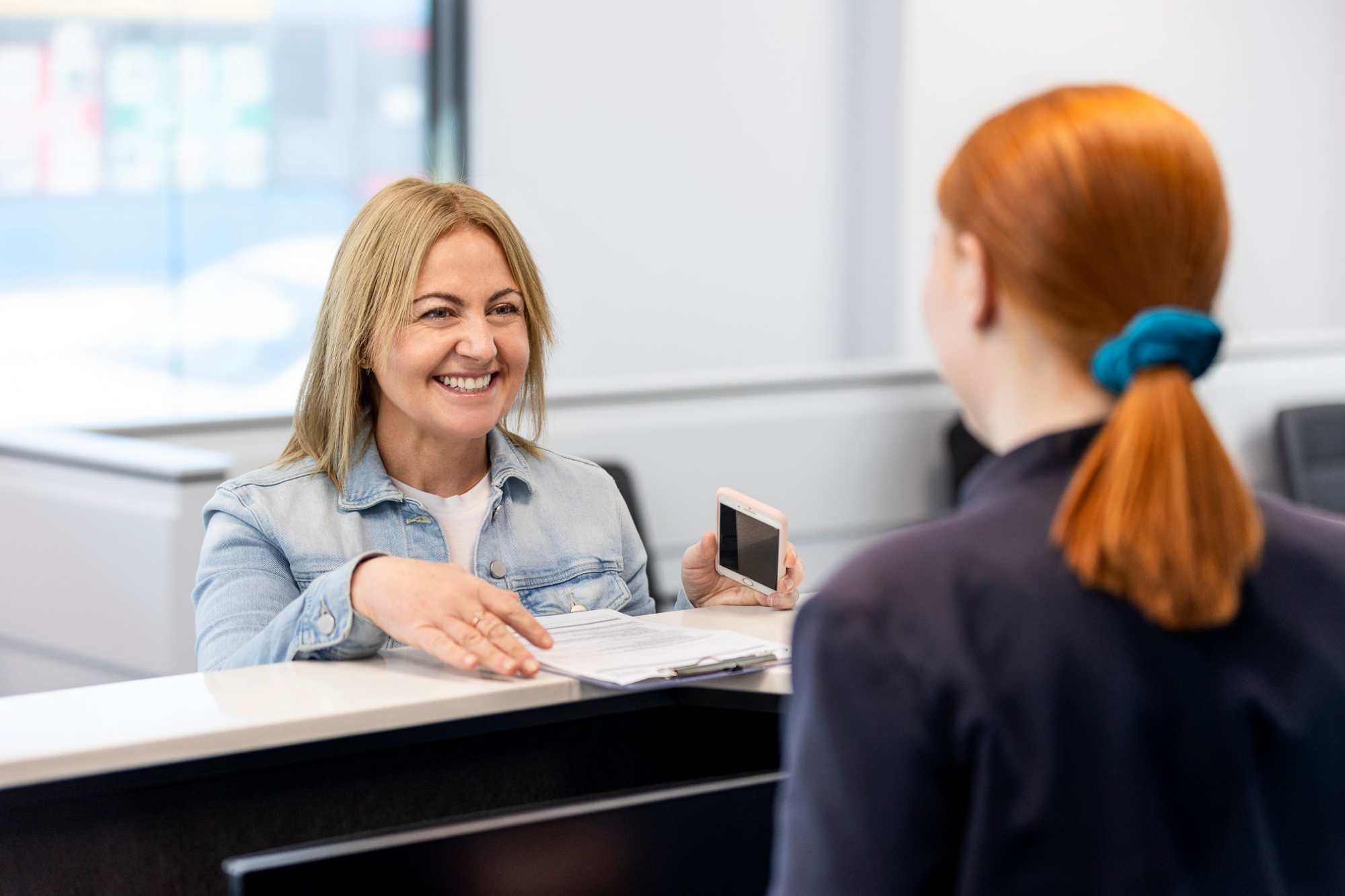 Woman Paying At The Fees & Billing Counter | Nearest Mammogram Clinic | Direct Radiology 