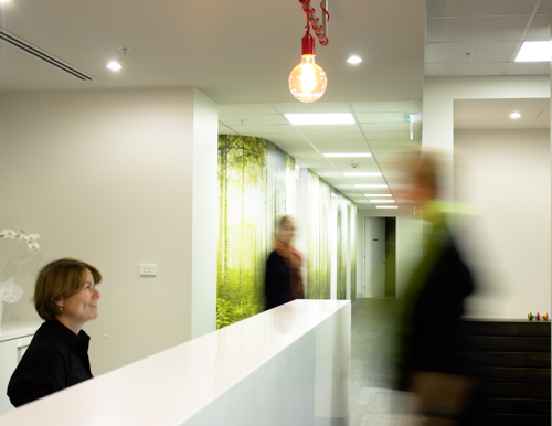 Office Lobby With A Receptionist and Blurred Client | Qscan Radiology Clinics | Direct Radiology