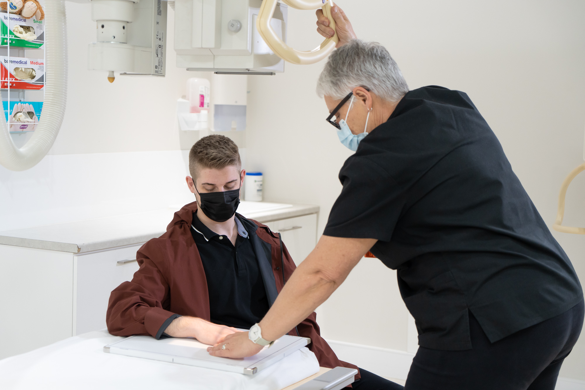 Doctor Conducting A Hand Ultrasound On Male Patient | Medical Imaging Clinic | Direct Radiology